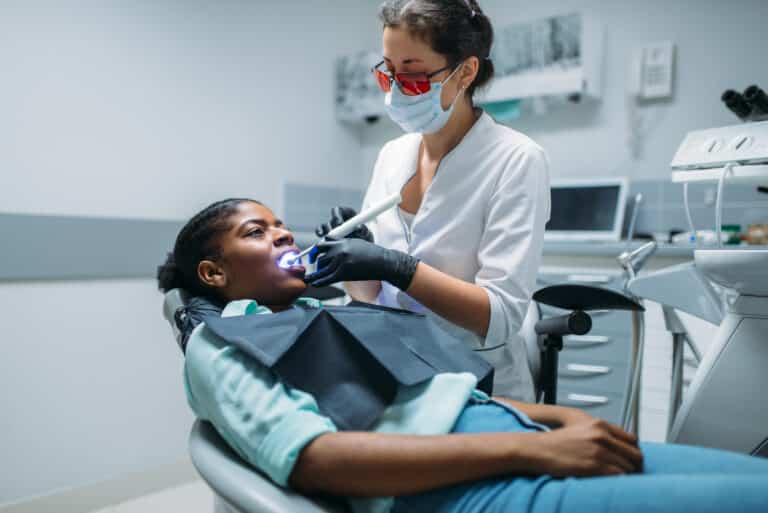 Dentist working on a filling while the patient worries about how long the numbness will last